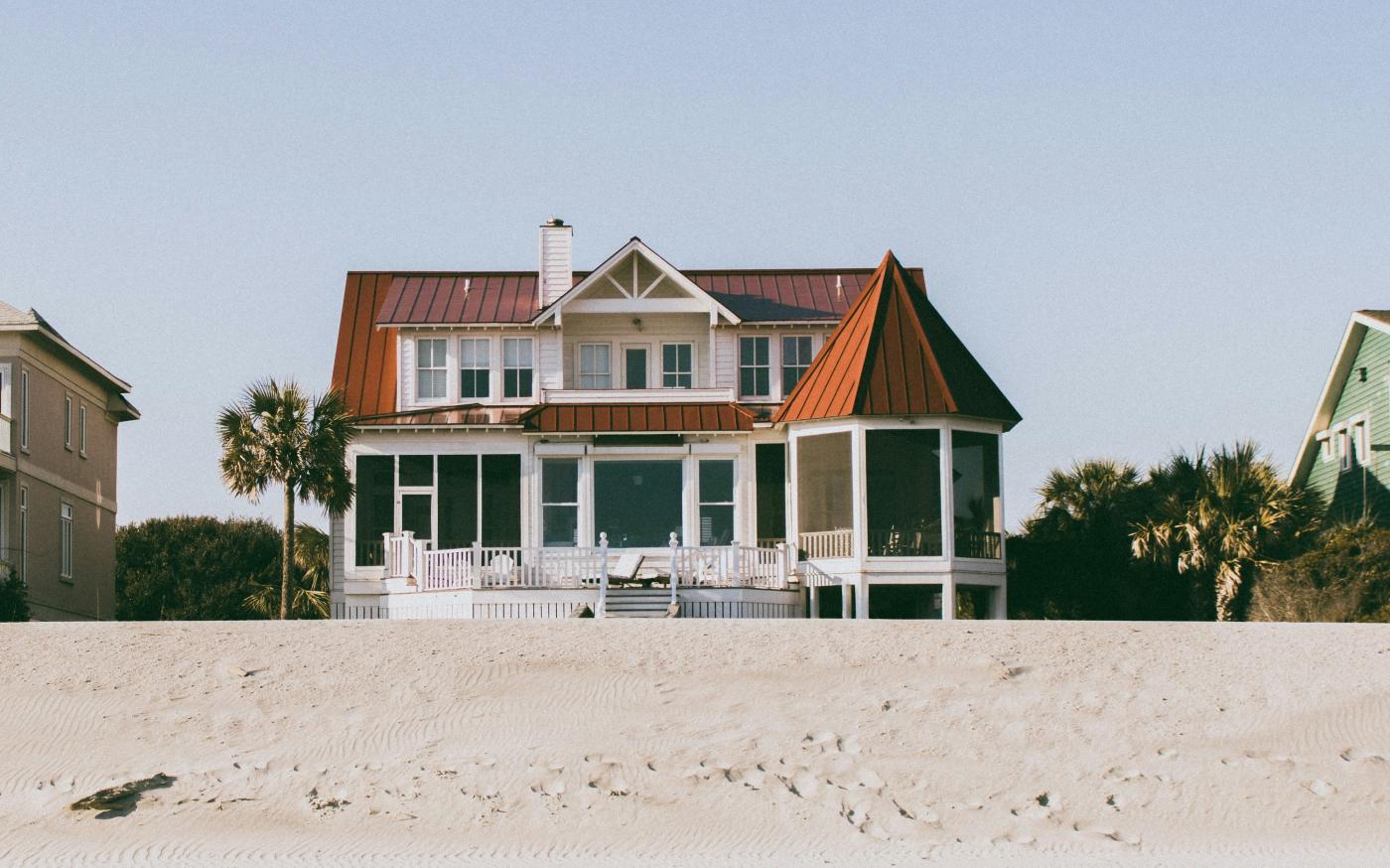 white and brown wooden 2-storey house by Deric courtesy of Unsplash.