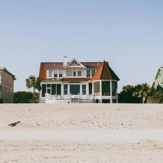 white and brown wooden 2-storey house by Deric courtesy of Unsplash.
