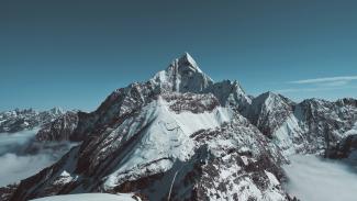 landscape photo of black and white mountain peak by ecmadao . courtesy of Unsplash.