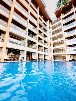 a large swimming pool next to a tall building by SJ 📸 courtesy of Unsplash.