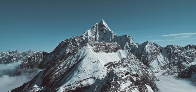 landscape photo of black and white mountain peak by ecmadao . courtesy of Unsplash.