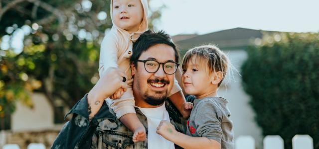 man in white shirt carrying girl in gray shirt by Nathan Dumlao courtesy of Unsplash.